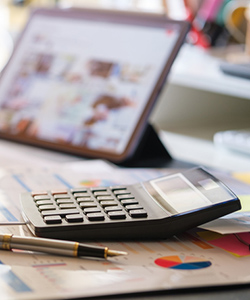 Calculator with iPad on desk