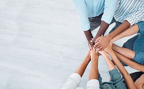 Multicultural hands together in middle of circle