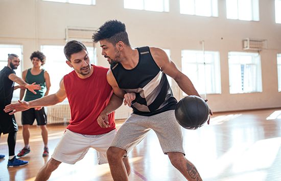 Two men playing basketball.